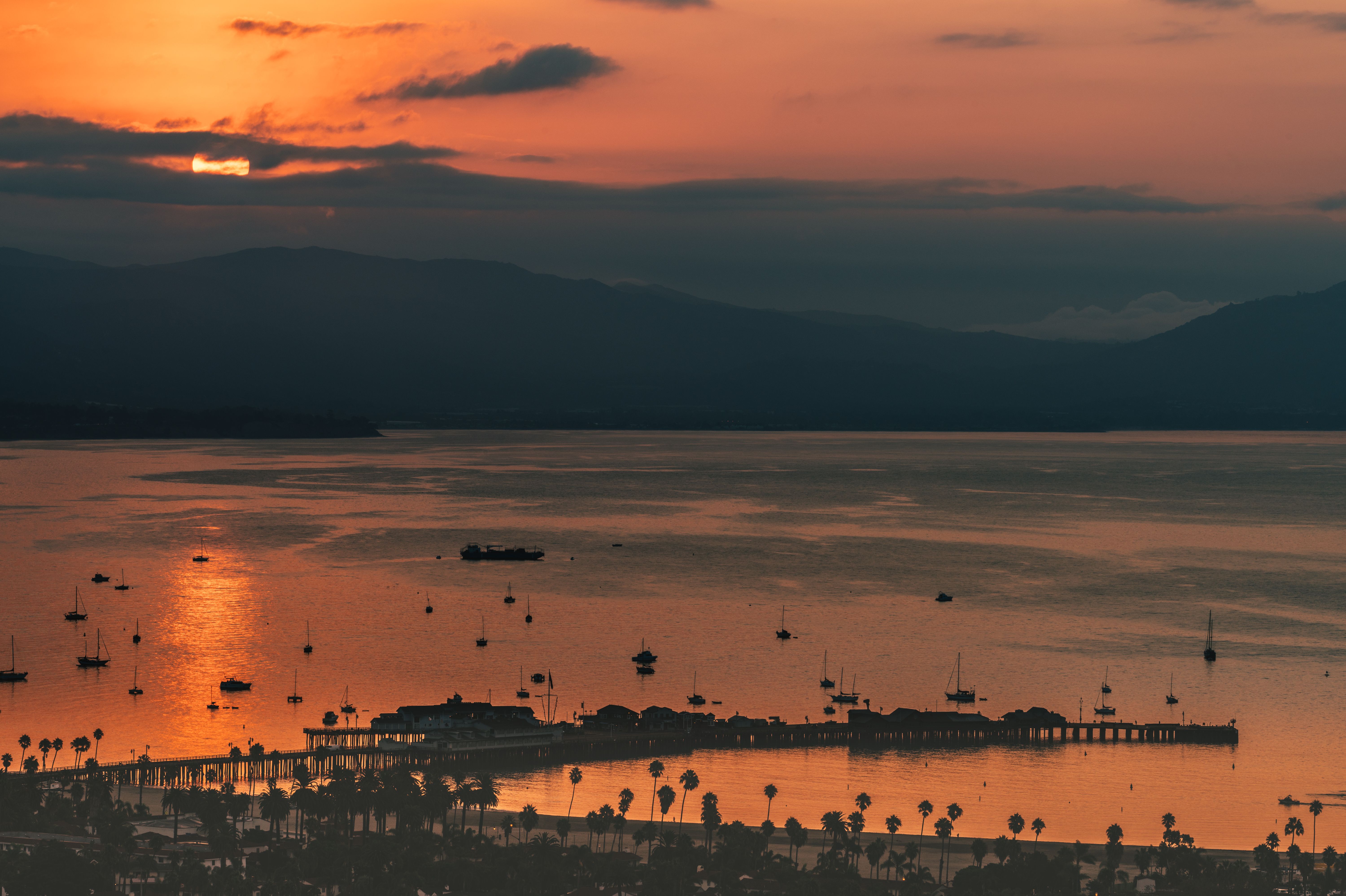 Dramatic sunset over Santa Barbara's Stearn's Wharf, with ocean and coastline in the background